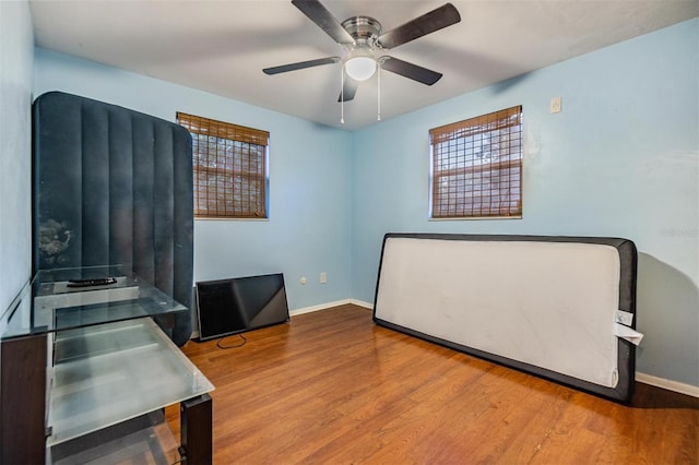 bedroom featuring hardwood / wood-style flooring and ceiling fan