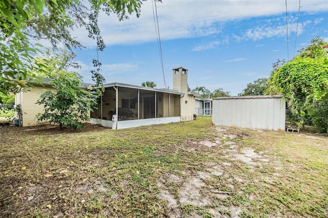 rear view of property with a sunroom