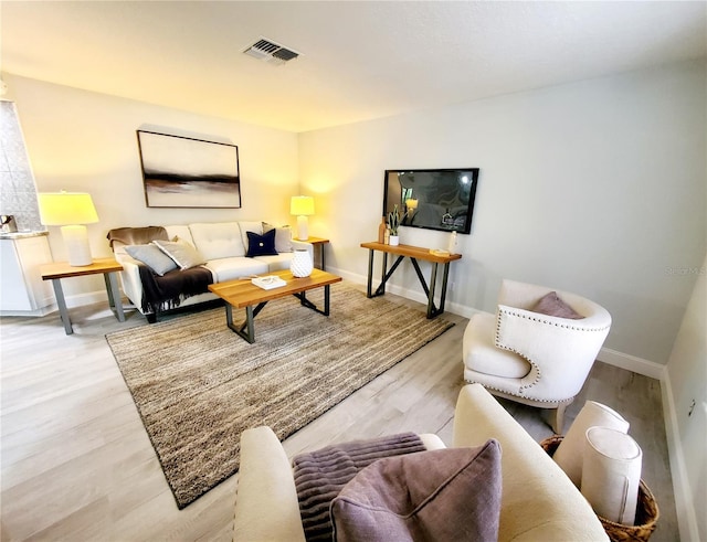 living room with light hardwood / wood-style flooring