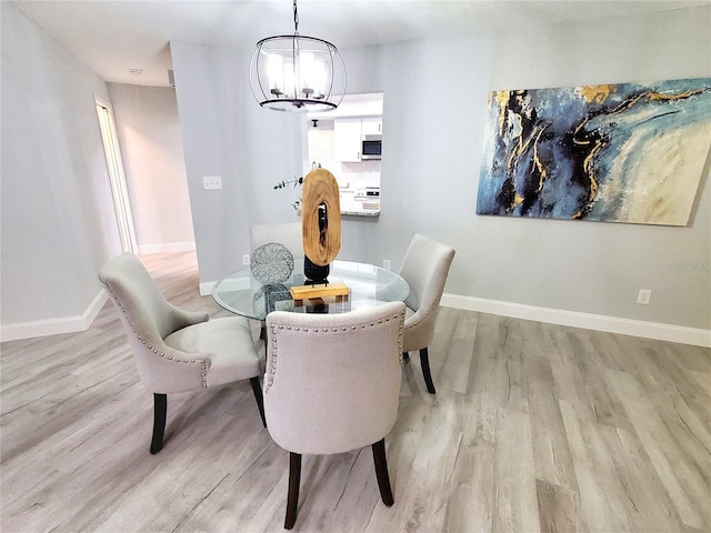 dining room featuring an inviting chandelier and light hardwood / wood-style floors