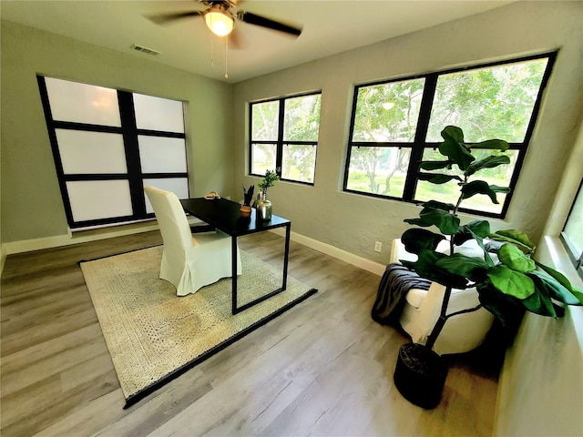 office space with ceiling fan and light wood-type flooring