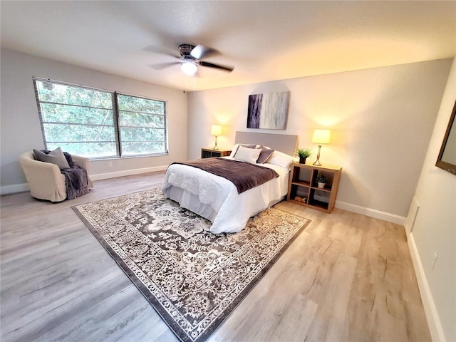 bedroom with ceiling fan and light hardwood / wood-style flooring