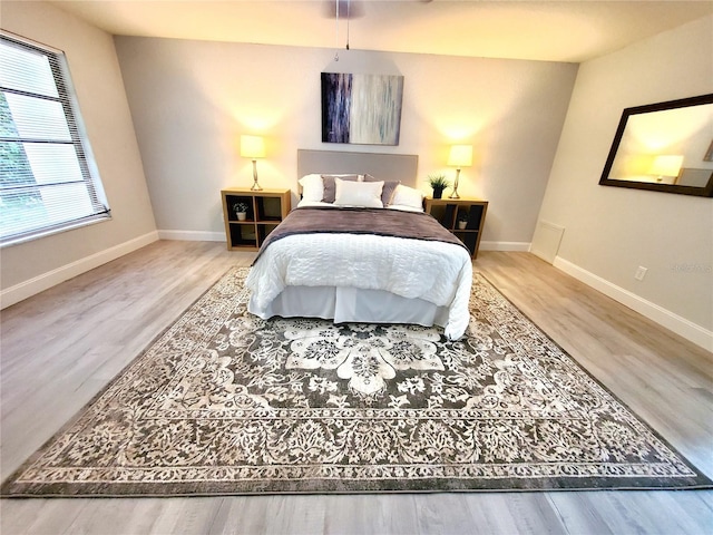 bedroom with hardwood / wood-style flooring