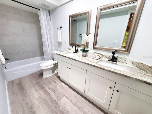 full bathroom featuring vanity, hardwood / wood-style floors, toilet, and shower / bath combo with shower curtain