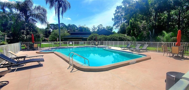 view of swimming pool featuring a patio area