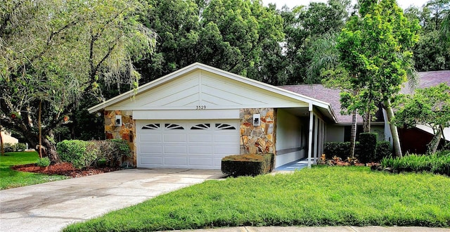 single story home featuring a garage and a front yard