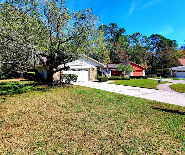 single story home featuring an attached garage, driveway, stone siding, and a front yard