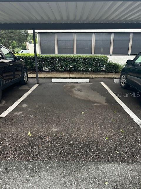 view of vehicle parking with a carport