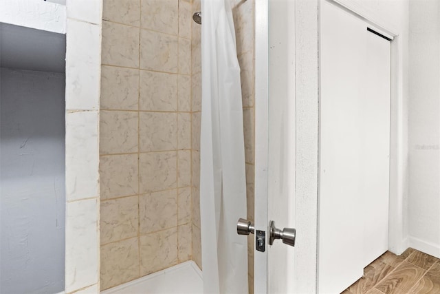 bathroom featuring hardwood / wood-style floors and curtained shower