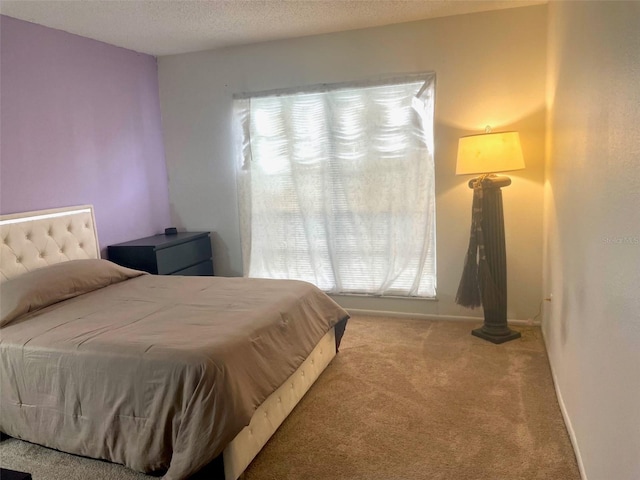 carpeted bedroom with a textured ceiling