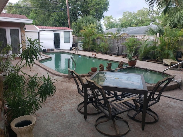 view of pool with a patio and an outdoor structure