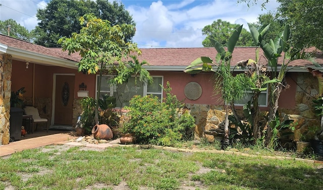 ranch-style home with a front lawn