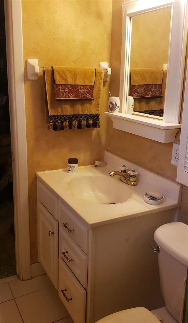 bathroom featuring toilet, vanity, and tile patterned floors