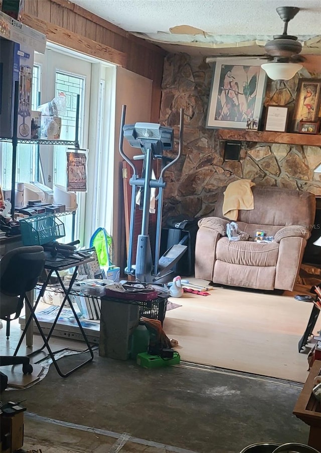 interior space featuring ceiling fan, concrete flooring, and a textured ceiling