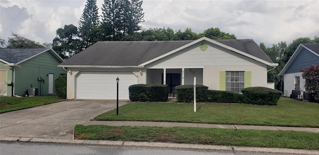 view of front of property featuring a garage, central air condition unit, and a front yard