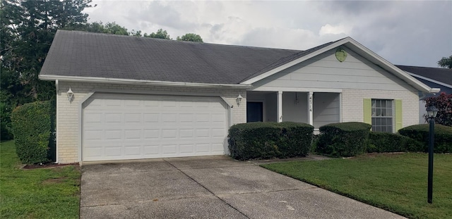 ranch-style house with a garage and a front lawn