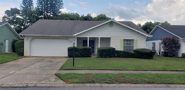 view of front of property with a garage and a front lawn