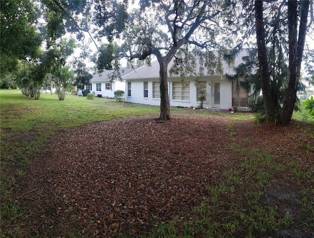 view of property exterior with a lawn