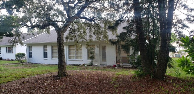 view of side of home featuring a lawn