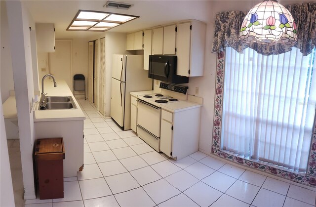 kitchen featuring light tile patterned flooring, white appliances, and sink