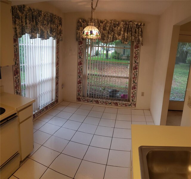 dining area featuring a healthy amount of sunlight and light tile patterned floors