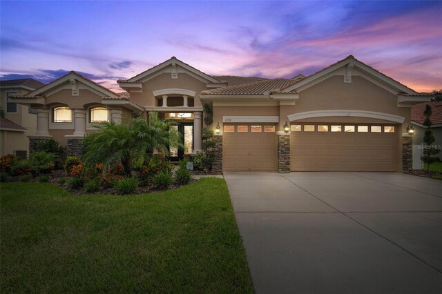 view of front facade featuring a garage and a lawn