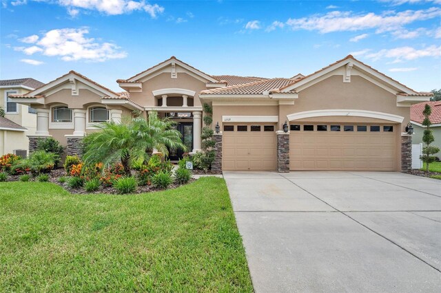 view of front facade with a garage and a front lawn