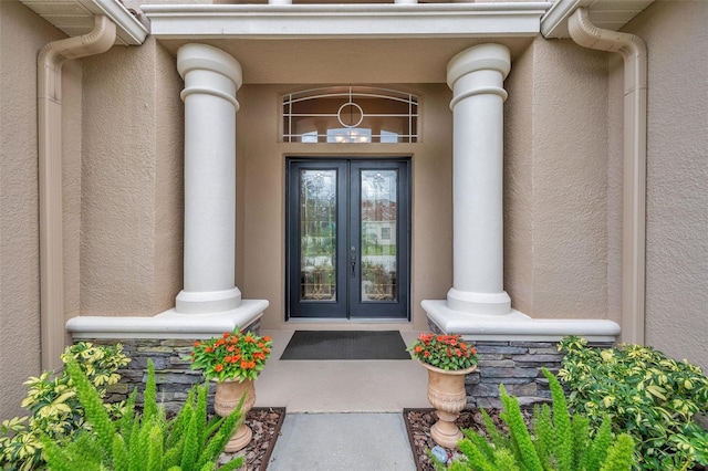 view of exterior entry featuring french doors