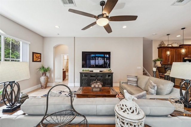 tiled living room with ceiling fan