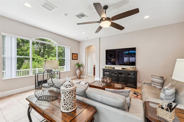 living room featuring ceiling fan and light tile patterned floors