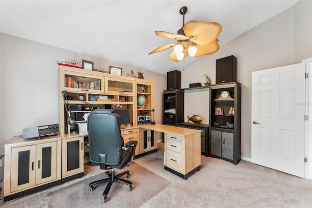 carpeted home office featuring vaulted ceiling and ceiling fan