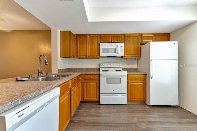 kitchen featuring sink, dark wood-type flooring, and white appliances