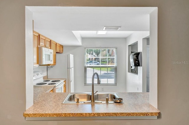 kitchen featuring sink and white appliances