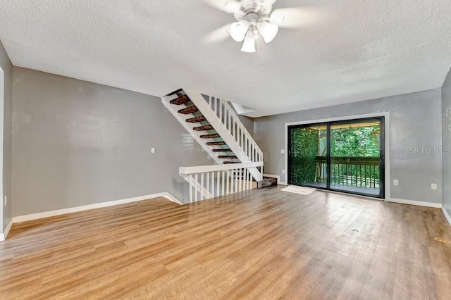 unfurnished room featuring a textured ceiling and light wood-type flooring