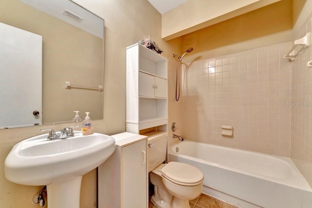 full bathroom with sink, shower / washtub combination, toilet, and tile patterned flooring