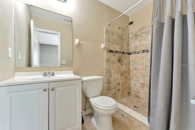 bathroom with vanity, toilet, tile patterned floors, and walk in shower