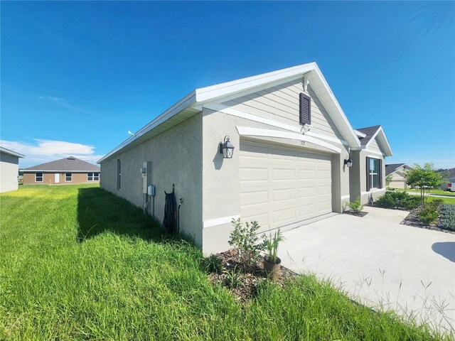 view of home's exterior featuring a garage and a lawn