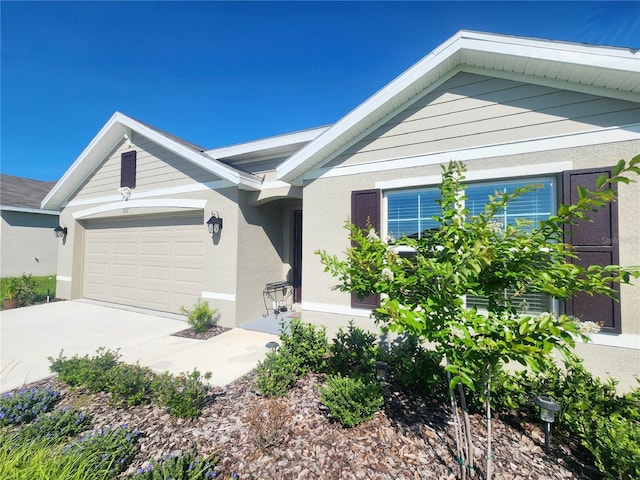 ranch-style house with a garage and stucco siding