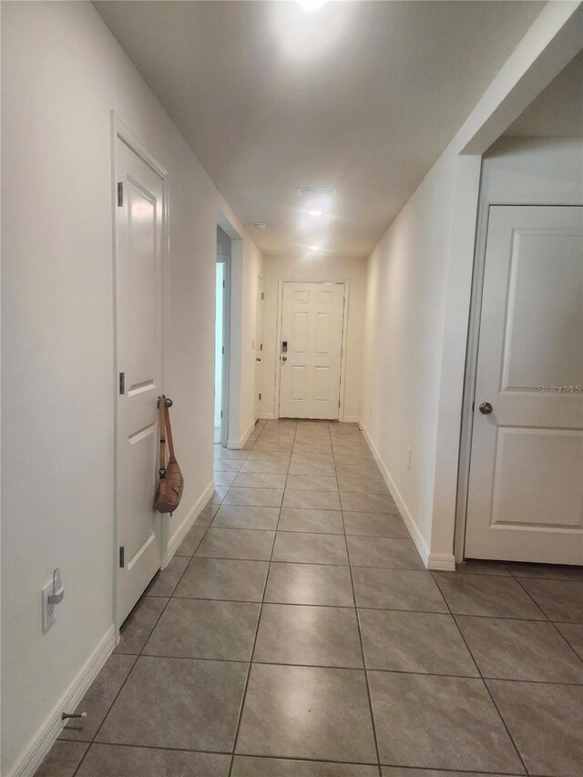 corridor featuring light tile patterned floors