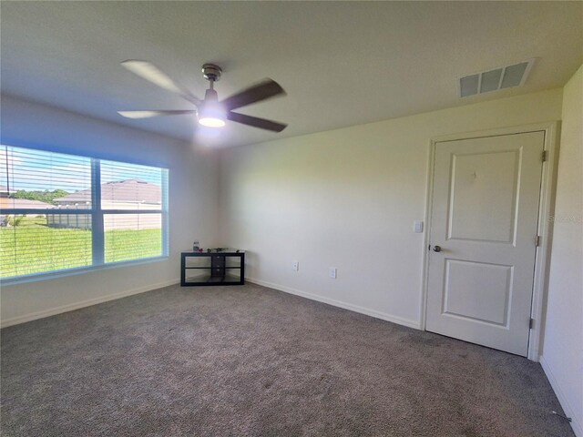 carpeted spare room with ceiling fan