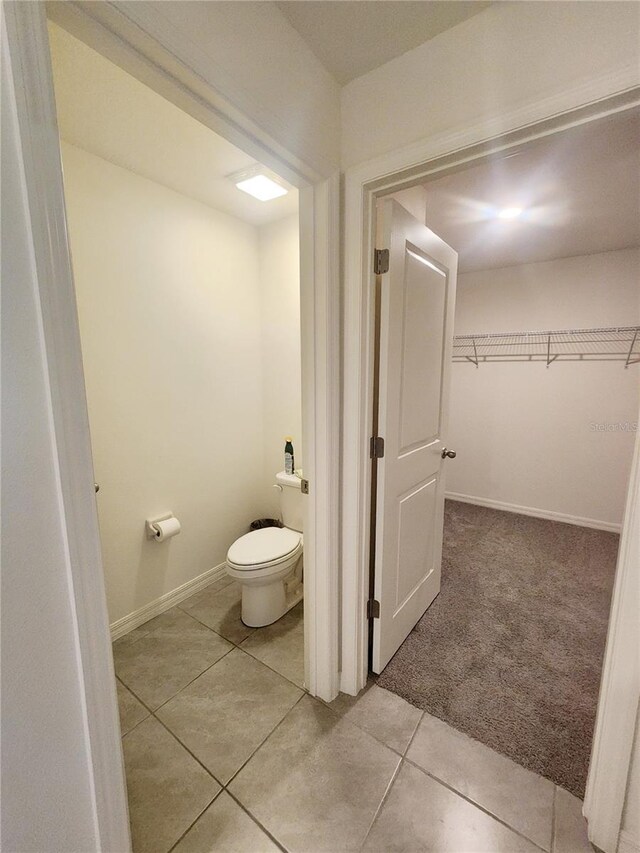 bathroom featuring toilet and tile patterned floors