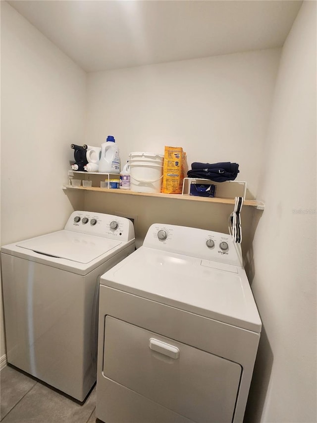 washroom with washer and dryer and light tile patterned floors