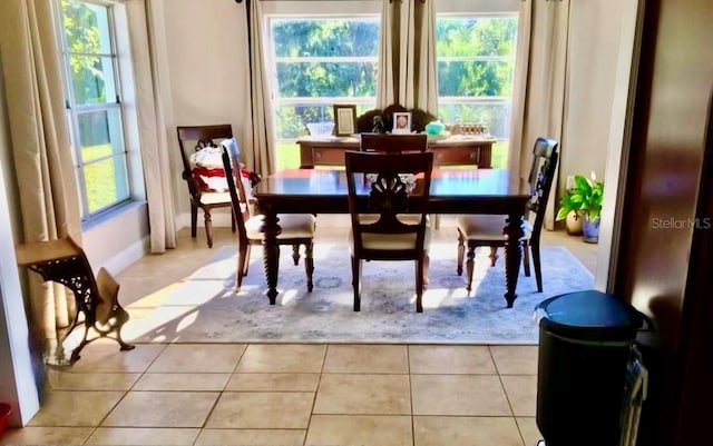 dining area with tile patterned flooring and baseboards