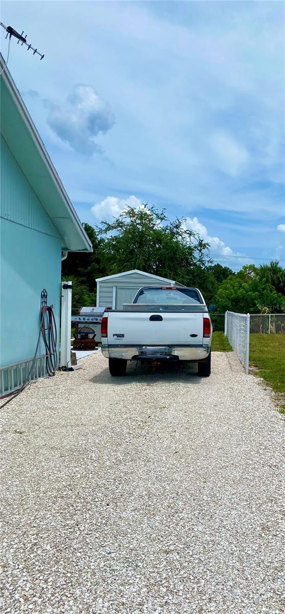 view of car parking featuring fence