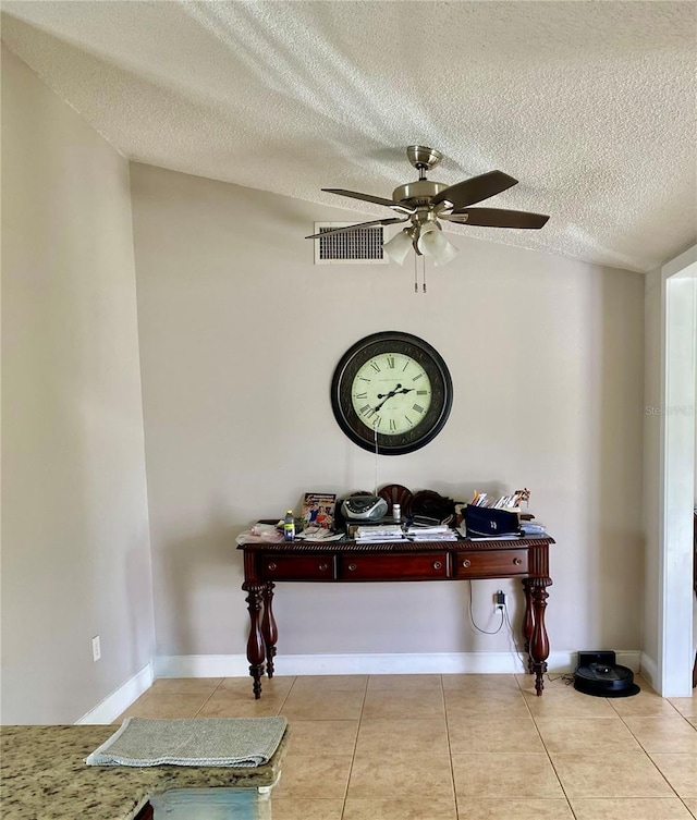 interior space featuring ceiling fan, a textured ceiling, visible vents, and baseboards