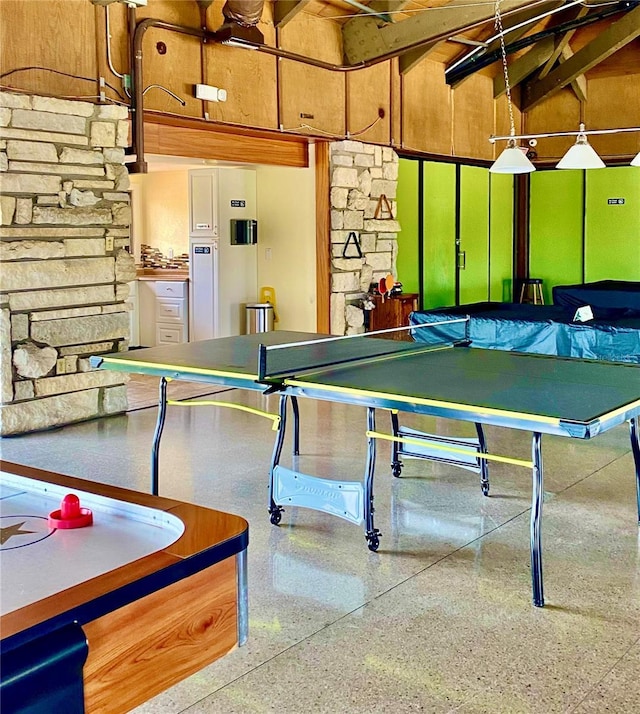 recreation room featuring speckled floor