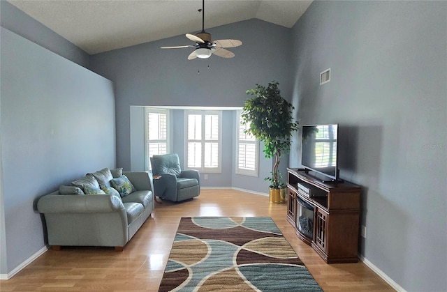 living room with high vaulted ceiling, light wood-type flooring, and ceiling fan