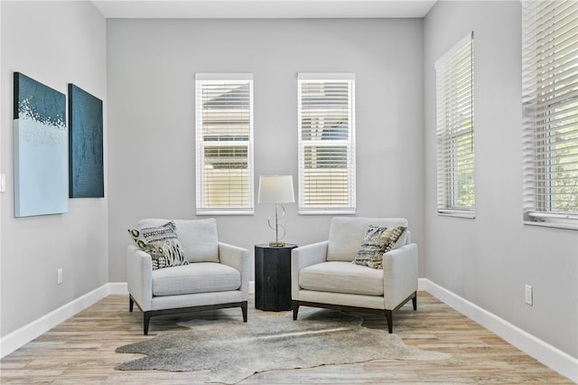 sitting room featuring baseboards and wood finished floors