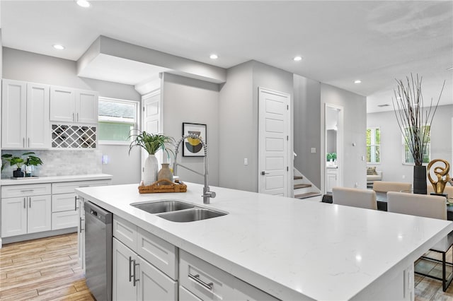 kitchen featuring recessed lighting, decorative backsplash, light wood-style floors, white cabinets, and dishwasher