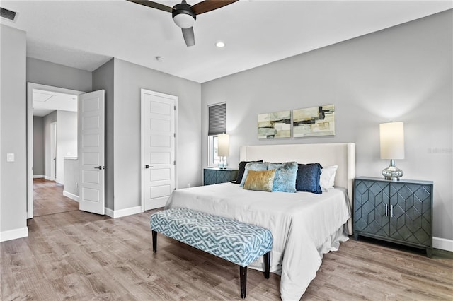 bedroom featuring visible vents, baseboards, and wood finished floors